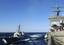 The guided-missile destroyer USS McFaul (DDG 74) pulls up alongside the nuclear-powered aircraft carrier USS Enterprise (CVN 65) for a refueling at sea.