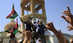 Libyans celebrate the liberation of their district of Qasr Bin Ghashir in Tripoli, LIbya, Saturday, Aug. 27, 2011.