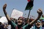 School students chant slogans against Moammar Gadhafi at the court square in the rebel-held capital Benghazi, Libya, Saturday, June 25, 2011.