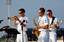 Musician 2nd Class Collin Reichow, left, Musician 3rd Class Jay Gillespie and Musician 3rd Class Robert Hall, assigned to Navy Ba.