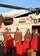 KODIAK, Alaska - Four of Santa's elves, (left to right) Pam Scholz of Norwich, Conn., Tiffani Scott of Campbell, N.Y., Tammy Knox of Warsaw, Mo., and Lynn Stiles of Evansville, Ind., all members of the Kodiak Officer's Spouses Association, haul presents from a Coast Guard Air Station Kodiak MH-60 helicopter on the runway at Port Lions northwest of Kodiak City on Kodiak Island Tuesday, Dec. 8, 2009. The Kodiak-based Coast Guard has been bringing Santa to the remote Kodiak Island villages for 32 y