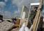 U.S. Navy Reservist, Boatswain's Mate 1st Class Cory Sills of Evansville, Ind., assists with search and rescue efforts after a tornado damaged a mobile home park in Evansville.