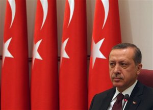 Turkish Prime Minister Recep Tayyip Erdogan look on as Turkey's military and civilian leaders gathered at a meeting to review disciplinary measures, a week after the government suspended three high-ranking generals implicated in a plot to topple the Islamic-rooted government, in Ankara, Turkey, Tuesday, Nov. 30, 2010.