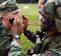 Spc. Wilfredo A. Mendez tapes an enemy combatant to quite him from shouting hate messages to the U.S. force during Mendez' Warrior Task Testing phase of the Soldier of the Year/Noncommissioned Officer of the Year competition Sept. 13.