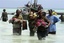 Tanzanian police carry bodies of children from the sea in Zanzibar, Tanzania, Saturday Sept 10, 2011. An overcrowded ship sank in deep sea off mainland Tanzania on Saturday with about 600 people onboard, and about 370 people are believed missing or dead.