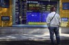 A man looks at stock update outside a securities firm in Tokyo, Japan, Monday, Dec. 15, 2008. Japan's benchmark Nikkei 225 stock average rose more than 400 points in morning trading from Friday's close at 8,2