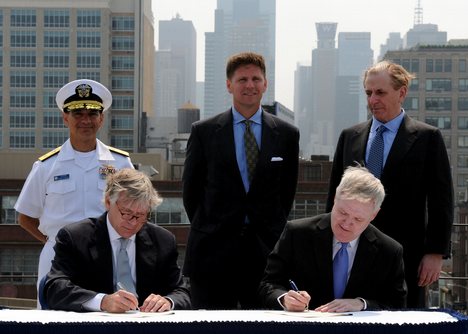 Secretary of the Navy (SECNAV) the Honorable Ray Mabus, right, and Lee Bollinger sign a treaty reestablishing the Naval Reserve Officer Training Corps at Columbia University.