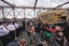 A police officer with a bullhorn addresses a large group of protesters affiliated with the Occupy Wall Street movement who attempted to cross the Brooklyn Bridge, effectively shutting parts of the roadway down, Saturday, Oct. 1, 2011 in New York.