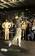 Sailors watch professional golfer Tiger Woods hit a few golf balls during a demonstration in the hanger bay of the nuclear powered aircraft carrier USS George Washington (CVN 73).