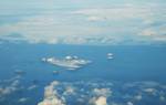 South aerial view of Súlnasker Geldungur, Hellisey, Álsey, Brandur, Suðurey, Heimaey, Bjarnarey, Elliðaey, with the Icelandic mainland in the background