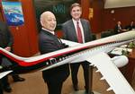 Mitsubishi Heavy Industries Ltd. President Kazuo Tsukuda, left, and Pratt & Whitney President Stephen Finger pose for the media during a news conference on the Mitsubishi Regioal Jet, or MRJ, project, at Mitsubishi Heavy´s headquarters in Tokyo Tue