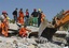 Rescuers work to save people from debris of collapsed buildings in Ercis, Van, eastern Turkey, following a powerful earthquake, Monday, Oct. 24, 2011.