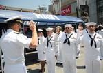 Rear Adm. Troy M. Shoemaker, commander of Carrier Strike Group (CSG) 9, conducts a mass reenlistment ceremony for seven Sailors at the 17th annual ESPN X-Games.