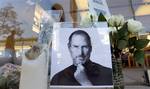 A tribute to Apple's Steve Jobs takes shape at the Apple store at Crocker Park in Westlake, Ohio on Thursday, Oct. 6, 2011.