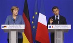 French President Nicolas Sarkozy, right, and German Chancellor Angela Merkel participate in a media conference at an EU summit in Brussels on Sunday, Oct. 23, 2011.