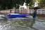 Two local residents navigate through flood waters with supplies while a humanitarian assistance survey team (HAST) with III Marine Expeditionary Force, not shown, conducts an assessment of Lopburi, Thailand Oct 30, 2011.