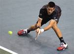 Novak Djokovic of Serbia returns the ball to Viktor Troicki of Serbia during their match in the Paris Tennis Masters tournament, Thursday, Nov.10, 2011, in Paris, France.