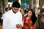 ** FILE ** Newly wed Bollywood couple Abhishek Bachchan, and Aishwarya Rai, right, hold hands as they offer prayers at the Venkateshwara temple at Tirupati, 156 kilometers (98 miles) north west of Chennai, India, in this April 22, 2007 file photo. Aishwarya Rai, Bollywood´s hottest bride, will take her new husband´s famous name to become Aishwarya Bachchan, said her father-in-law, Indian superstar actor Amitabh Bachchan.