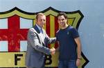 Barcelona's new player Cesc Fabregas, right, shake hands with FC Barcelona President Sandro Rosell, left, during his presentation at the Nou Camp stadium in Barcelona, Spain, Monday, Aug. 15, 2011. Fabregas, who come back to his boyhood club after eight seasons with Arsenal, signed a five-year contract Monday. Terms of Fabregas' contract were not announced but Spanish media reported the price tag of the transfer at about euro 40 million ($57 million).