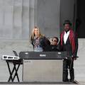 Sheryl Crow (left), will.i.am (right), and Herbie Hancock (seated) finish their performance of the Bob Marley song 