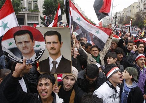 Pro-Syrian regime protesters, shout pro-Syrian President Bashar Assad slogans during a demonstration in Damascus, Syria, on Wednesday Nov. 16, 2011, protesting against the Arab League meeting being held in Morocco.