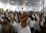 Bahraini Shiite Muslims chant slogans to free prisoners during a sermon Friday, June 10, 2011, in Diraz, Bahrain, when Sheik Issa Qassem, Bahrain's top Shiite cleric, said Bahrain should free political prisoners and that the nation's reputation is being damaged by prosecuting doctors, teachers, youths, women, clerics and other professionals arrested during the crackdown on anti-government protesters.