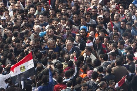 Pro-reform leader and Nobel peace laureate Mohamed El-Baradei, center, is surrounded by protesters during his arrival for Friday prayers in Cairo's Tahrir square, Egypt, Friday, Nov. 25, 2011.