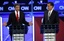 Republican presidential candidate Texas Gov. Rick Perry speaks as former Massachusetts Gov. Mitt Romney listen during a Republican presidential debate in Washington, Tuesday, Nov. 22, 2011.