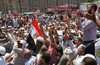 Egyptian protesters peer out of their tent in Tahrir Square, the focal point of the Egyptian uprising, in Cairo, Egypt, Friday, July 22, 2011