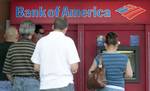 This photo taken Friday, Oct. 14, 2011, shows customers in line a Bank of America ATM in Hialeah, Fla. Bank of America said Tuesday, Oct. 18, 2011, it earned $6.2 billion in the third-quarter largely from accounting gains and the sale of a stake in a Chinese bank.