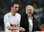 Marseille's coach Didier Deschamps, right, reacts with Marseille's Morgan Amalfitano, after defeating Paris Saint Germain during their League One soccer match at the Velodrome Stadium, Marseille, southern France, Sunday, Nov. 27, 2011.