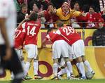 Mainz's players celebrate their team's opening goal during the German first division Bundesliga soccer match between FSV Mainz 05 and Bayern Munich in Mainz, Germany, Sunday, Nov. 27, 2011.