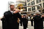 Musician 3rd Class Patrick Reynolds, from Clarksville, Tenn., and a member of the U.S. Navy Band Great Lakes, plays a trombone in the Chicago Thanksgiving Day Parade.