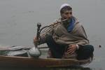 A Boatman Hubble Bubble on a cold day Dal Lake in Srinagar, on December 01,2011.