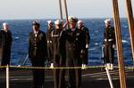 Capt. Bruce H. Lindsey, commanding officer of the Nimitz-class aircraft carrier USS Carl Vinson (CVN 70), is presented with the folded national ensign during a burial at sea ceremony for 20 former service members.