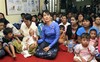 Opposition leader and Nobel peace laureate Aung San Suu Kyi, center, attends an event to mark World AIDS Day cerebration at National League for Democracy (NLD) party's headquarters in Yangon, Myanmar, Thursday, Dec. 1, 2011.