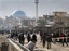 Afghans are seen near the scene of a suicide attack in Kabul, Afghanistan, Tuesday, Dec. 6, 2011.