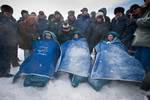 Kaleri, Skripochka and Kelly sit in chairs after they landed. Soyuz TMA-01M undocked from the Poisk module at 4:27 GMT on 16 March 2011. after they landed near the town of Arkalyk, Kazakhstan on Wednesday, March 16, 2011. NASA Astronaut Kelly, Russian Cosmonauts Skripochka and Kaleri are returning from almost six months onboard the International Space Station where they served as members of the Expedition 25 and 26 crews. Photo Credit: (NASA/Bill Ingalls)