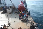 NEW ORLEANS - Crewmembers aboard the Coast Guard Cutter Cypress, homported in Mobile, Ala., work an old mooring with a sunken buoy attached, in the Southwest Pass near the mouth of the Mississippi River, Nov. 21, 2011. The Cypress and its crew is equipped to perform search and rescue, law enforcement, homeland security, pollution response, and domestic ice breaking mission, as well as fulfilling its primary mission of servicing and maintaining aids to navigation. U. S. Coast Guard photo by Seaman Apprentice Aaron Reeve. (1465724) ( CGC Cypress works buoys )