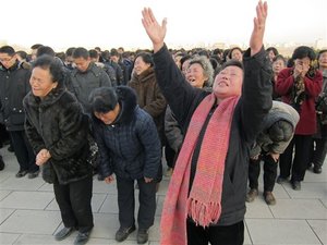 North Koreans cry and scream in a display of mourning for their leader Kim Jong Il at the foot of a giant statue of his father Kim Il Sung in Pyongyang, North Korea, after Kim Jong Il’s death was announced Monday, Dec. 19, 2011.