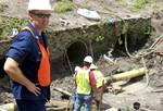 MANGO, Fla. -- Petty Officer 2nd Class Donald Vaughn, a Coast Guard Reservist and marine science technician (MST) from the Coast Guard Sector St. Petersburg Response Division, inspects a broken pipeline that carries jet fuel between Tampa and Orlando that ruptured into Mango Creek July 22, 2011. MSTs are the Coast Guards safety and environmental health experts ashore and they may be assigned to the National Strike Force for oil and hazardous-material response. They conduct marine-safety activiti