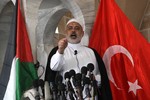 Flanked by a Palestinian flag, left and a Turkish flag, right, Gaza Hamas Prime Minister Ismail Haniyeh reacts as he speaks during Friday prayers at the Al-Omari mosque in Gaza City, Friday June 4, 2010. Tensions are high in the aftermath of an Israeli naval raid targeting an aid flotilla to Gaza that killed nine pro-Palestinian activists, mostly Turks, in the ensuing clash. Israel's blockade of the Gaza Strip was imposed after the militant Hamas group seized power in the territory three years ago. Israel says the blockade is meant to keep weapons out of Gaza and to put pressure on its Hamas rulers. (Photo by Ahmed Deeb/WN)