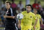 Villarreal's Giuseppe Rossi from Italy, right, duels for the ball with Bayern Munich's Holger Badstuber, left, during the group A Champions League soccer match at at the Madrigal stadium in Villarreal, Spain, Wednesday, Sept. 14, 2011.