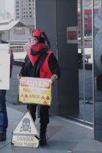 Protester in 'protective suit' with danger signs