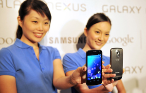 Models hold the new Samsung Galaxy Nexus Android phone during its official launch in Hong Kong in October. The new smartphone runs Google's Android "Ice Cream Sandwich" operating system.