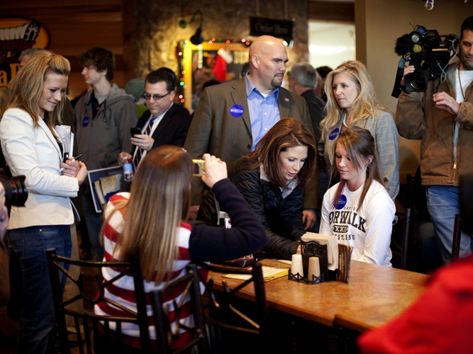 Minnesota Rep. Michele Bachmann signs autographs at the Pizza Ranch in Indianola, Iowa, on Wednesday. The restaurant was largely empty aside from a few local Iowans, media and Bachmann staff.