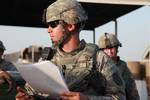 U.S. Army Staff Sgt. Samuel Ward, team leader and convoy commander, gives a pre-mission brief emphasizing safety and diligence to soldiers from the Guardians Maneuver Element, 17th Fires Brigade prior to departing Contingency Operating Base Basra, Iraq, on June 2, 2010. DoD photo by Staff Sgt. Adelita Mead, U.S. Army. (Released)