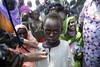 File - A child is checked by a member of the Nepalese special forces of the African Union – United Nations Hybrid Operation in Darfur (UNAMID), during the medical campaign in Kuma Garadayat, a village located in North Darfur.