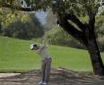 Rory McIlroy from Northern Ireland plays a ball on the seventh hole during the final round of the Desert Classic golf tournament in Dubai, United Arab Emirates, Sunday, Feb. 1, 2009.