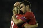 Serbia's Branislav Ivanovic, right, and Milos Krasic hug each other in celebration after Ivanovic scored a goal against Italy during their Euro 2012 Group C qualifying soccer match in Belgrade, Serbia, Friday, Oct. 7, 2011.